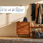 Winter coats, a knit hat, gloves, a gym bag and a topped coffee arranged in a sunlit entryway, with the It’s a Vibe by DAOFitLife logo.