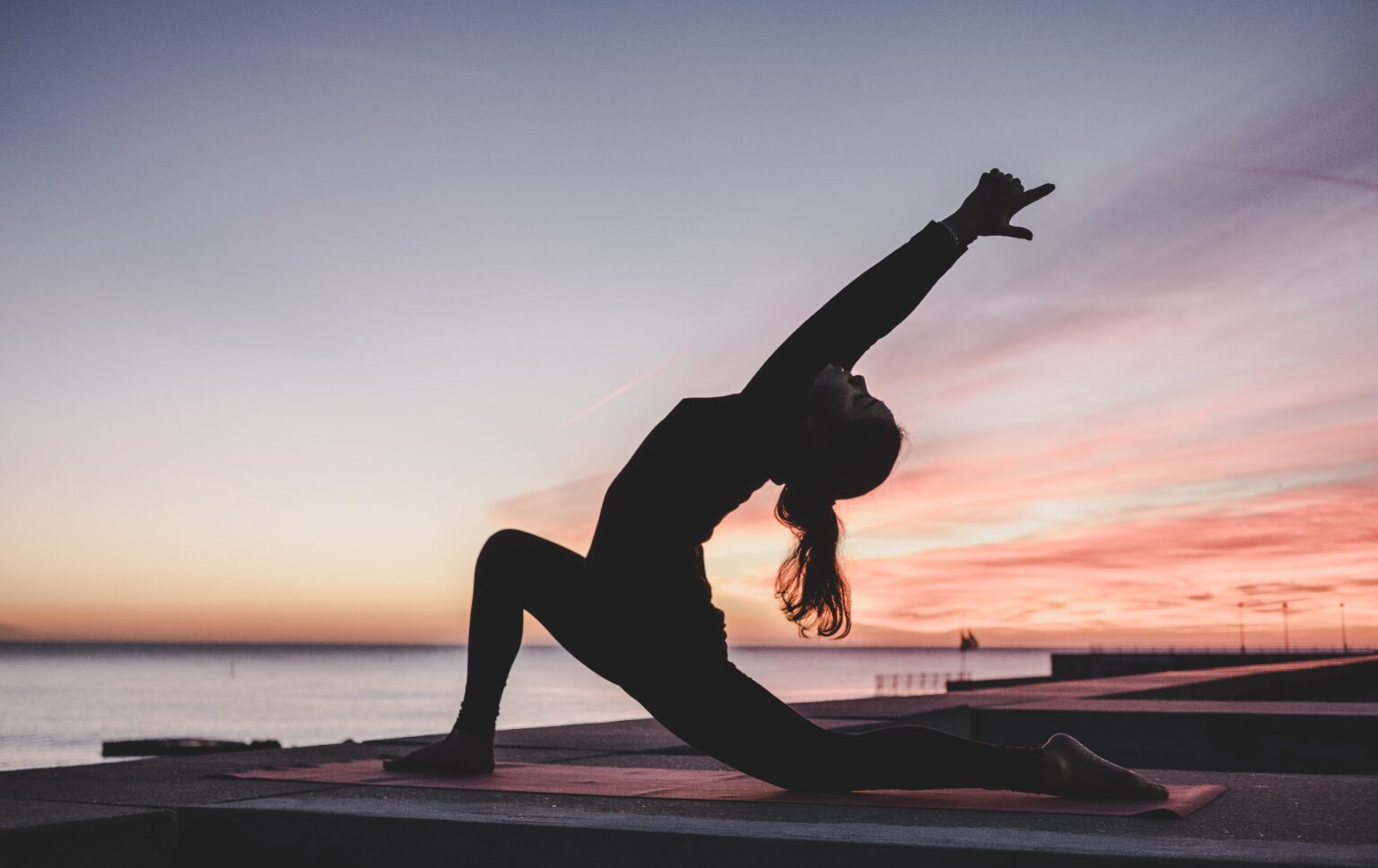 Lady doing yoga pose on Beach