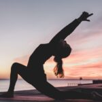 Lady doing yoga pose on Beach