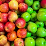 green and red apples on white plastic container