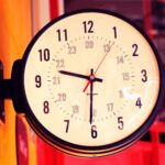 black and white analog clock at 10 00