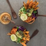 salad on brown wooden bowl with dip