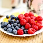 strawberries and blue berries on palte
