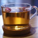clear glass mug with brown liquid