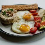 sliced bread with egg and vegetable on white ceramic plate