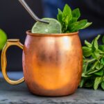 brass-colored mug with sliced lime