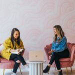 3 women sitting on chair