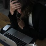 woman in black blazer sitting on chair