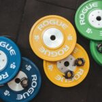 three pairs of assorted-color Rogue bumper plates