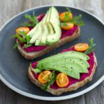 two sliced breads with avocado on top