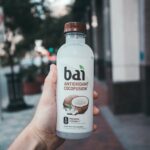 person holding Bai antioxidant cocofusion drink bottle