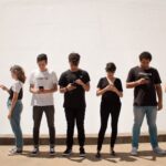 group of people standing on brown floor
