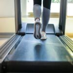 Close-up shot of a person exercising on a treadmill, showcasing fitness and health focus.