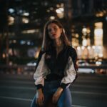 woman sitting on a fire hydrant