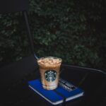 Starbucks plastic cup on blue book