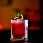 red liquid in clear drinking glass