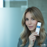 Woman holding Aquaphor stick